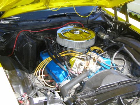 1967 Ford Ranchero - Close-up of a car's engine bay, showing the air filter, spark plug wires, and valve covers.