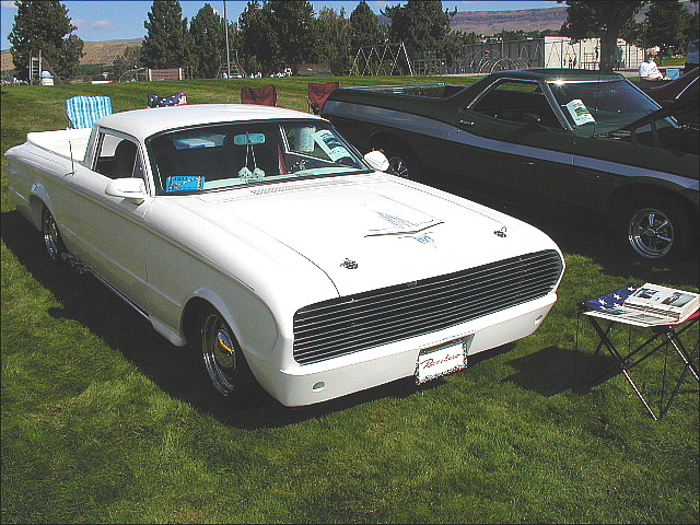 White Ford Ranchero coupe-utility with bumperless nose at an outdoor car show
