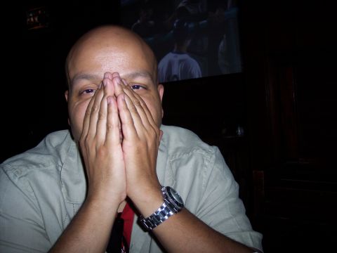 1995 Ford Probe - A man hides his face while a game plays on a screen behind him.