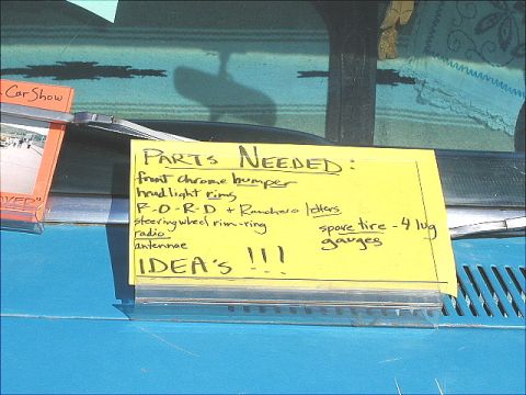 1967 Ford Ranchero - A yellow sign lists various parts needed for a vehicle, including Ford and Ranchero specific items.