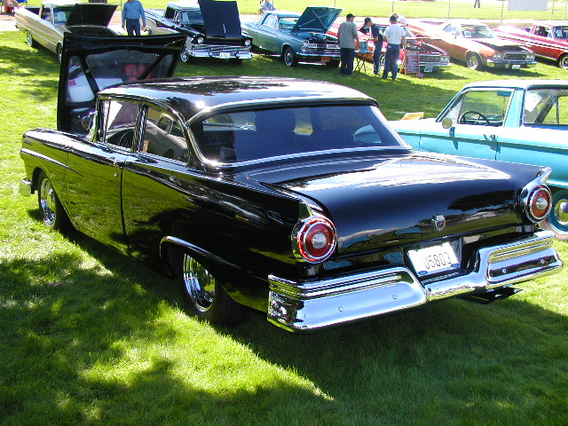 Black 1957 Ford Fairlane 500 rear view with chrome bumper and round taillights