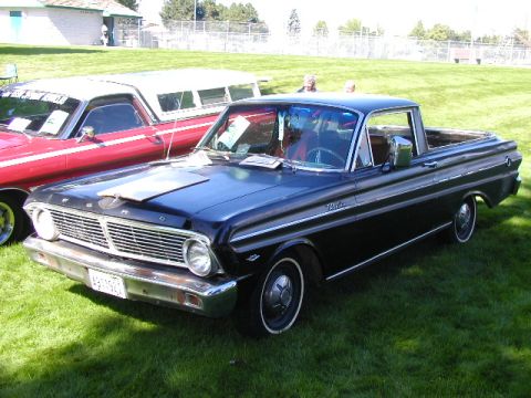 1967 Ford Ranchero - A black 1965 Ford Falcon Ranchero is parked on a grassy field next to another vehicle.