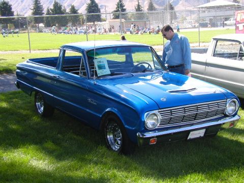 1967 Ford Ranchero - A blue 1967 Ford Ranchero is displayed on a grassy field next to another vehicle.
