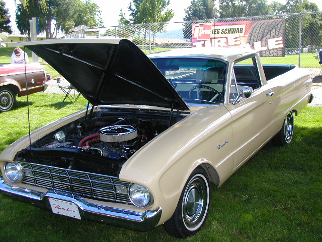Tan Ford Falcon Ranchero with hood up at a car show showing its V8 engine