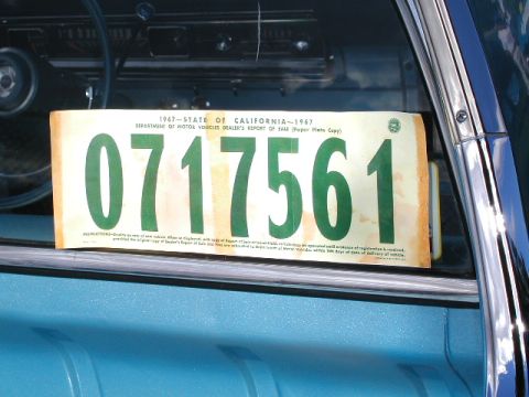 1967 Ford Ranchero - A 1967 California Department of Motor Vehicles dealer's report of sale paper plate is displayed inside a vehicle.