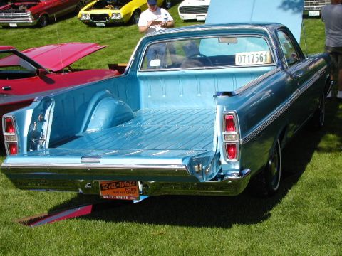1967 Ford Ranchero - A blue 1967 Ford Ranchero is parked on grass with other vehicles.