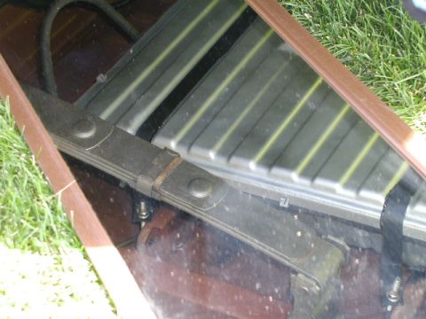 1967 Ford Ranchero - Close-up view of a vehicle's leaf spring assembly positioned above a ribbed radiator grille.