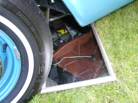 1967 Ford Ranchero - A close-up view of the undercarriage reveals the transmission and exhaust system of a vehicle.