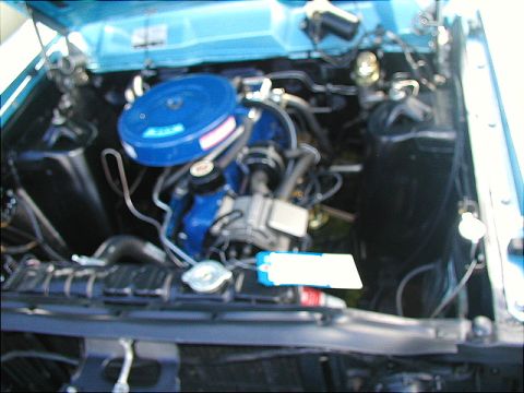 1967 Ford Ranchero - Close-up view of an engine bay, showing various mechanical parts and wiring.