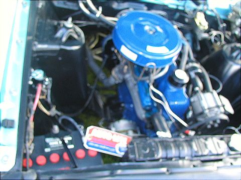 1967 Ford Ranchero - Close-up of a vehicle's engine bay, a blue air filter housing and battery.