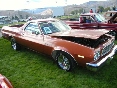 1967 Ford Ranchero - A brown Ford Ranchero is displayed on a grassy field with other vehicles present.