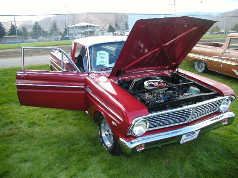1967 Ford Ranchero - A red 1963 Ford Falcon Ranchero is displayed with its hood and door open, with another vehicle visible in the background.