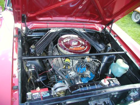 1967 Ford Ranchero - Engine bay of a classic Ford vehicle, likely a Ranchero, with a V8 engine.