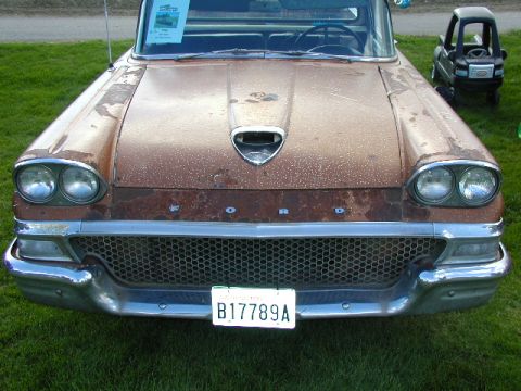 1967 Ford Ranchero - This 1959 Ford Ranchero displays its distinctive front end, a prominent grille and dual headlights, with a patina of rust.