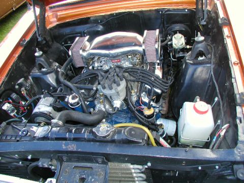 1967 Ford Ranchero - The engine bay of a vehicle, a V8 engine with chrome accents and dual air cleaners.