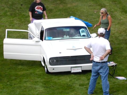 1967 Ford Ranchero - A white 1960 Ford Ranchero is displayed on a grassy field with people gathered around.