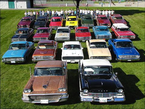 1967 Ford Ranchero - A group of classic Ford Rancheros are gathered on a grassy field, with a rusty brown 1957 model in the foreground.