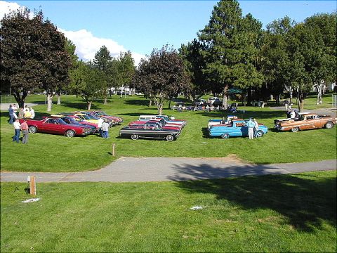 1967 Ford Ranchero - A red 1967 Ford Ranchero is displayed alongside other classic vehicles at an outdoor car show.