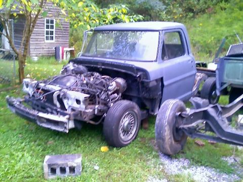 2002 Ford Crown Victoria - This disassembled Ford truck chassis is missing many of its body panels and engine components.