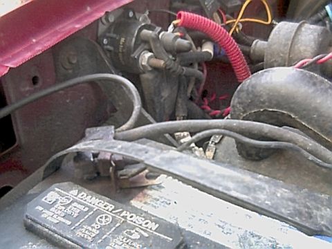 1994 Ford Bronco - Engine bay detail showing battery and wiring harness, part of a larger vehicle.