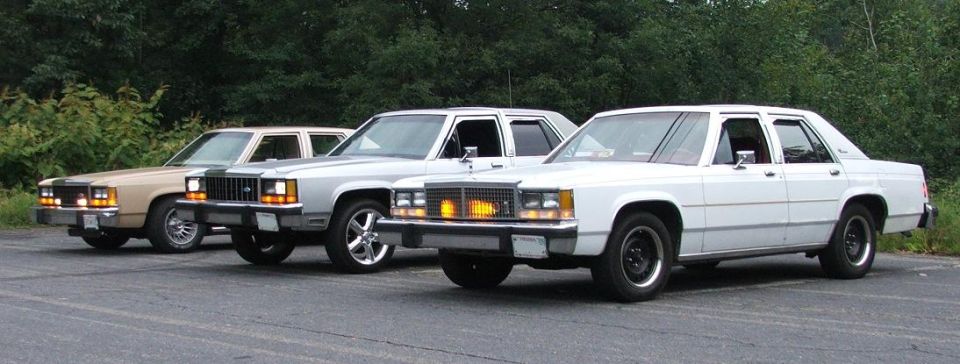 Three 1985 Ford Crown Victoria LTD sedans parked on asphalt
