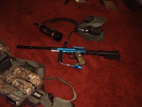 1988 Ford Bronco - A paintball gun, mask, and CO2 tank are laid out on a red carpeted surface.