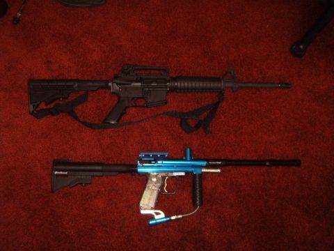 1988 Ford Bronco - Two firearms, one black rifle and one blue paintball gun, are displayed on a red carpeted surface.