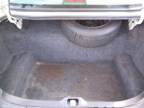 1998 Ford Crown Victoria - Trunk interior of a 1998 Ford Crown Victoria, showing the spare tire compartment.