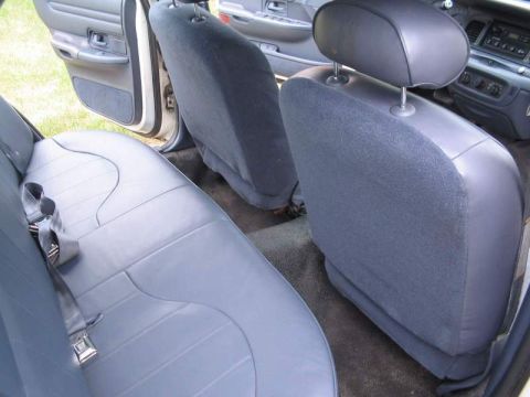 1998 Ford Crown Victoria - Interior view of a car, focusing on the rear seating area and dashboard details.