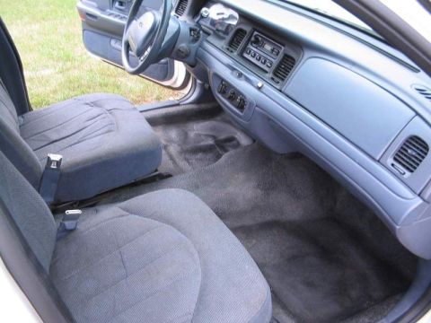1998 Ford Crown Victoria - The interior of a 1998 Ford Crown Victoria features cloth seats and a blue dashboard.