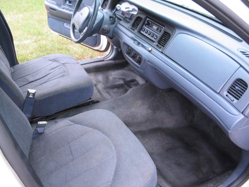 Interior of a 1998 Ford Crown Victoria showing front seats and dashboard