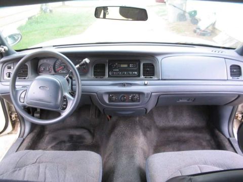 1998 Ford Crown Victoria - The interior of a 1998 Ford Crown Victoria is shown, the dashboard and front seats.