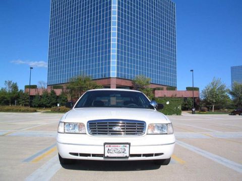 1998 Ford Crown Victoria - Front view of a white 1998 Ford Crown Victoria parked in front of a glass office building.