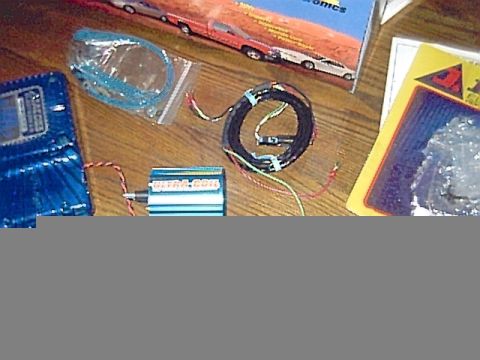 1994 Ford Bronco - Various automotive electronic components are laid out on a wooden surface.