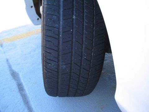 1998 Ford Crown Victoria - Close-up view of a car's tire and fender section.