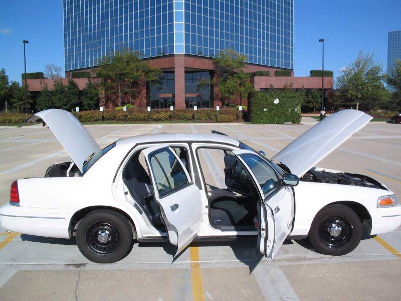 White 1998 Ford Crown Victoria with all doors and hood open