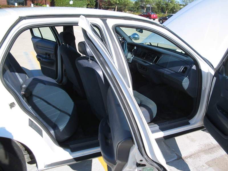 1998 Ford Crown Victoria interior showing front and rear seats with doors open