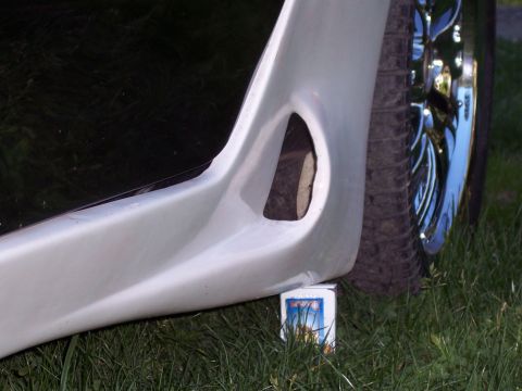 1996 Ford Probe - A custom car body kit side skirt is shown, resting on a small box in the grass.