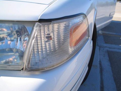 1998 Ford Crown Victoria - Close-up of the front passenger side headlight and fender of a 1998 Ford Crown Victoria.