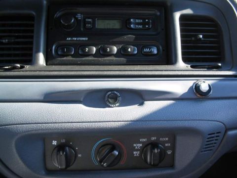 1998 Ford Crown Victoria - Interior view of a 1998 Ford Crown Victoria's dashboard, highlighting the central console with radio and climate controls.