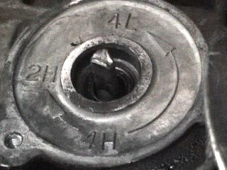 1991 Ford Bronco - Transfer case shift mechanism shows 2H, 4H, and 4L settings with directional arrows.