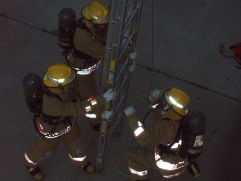 1981 Ford Bronco - Firefighters practice ladder drills, demonstrating teamwork and safety protocols.