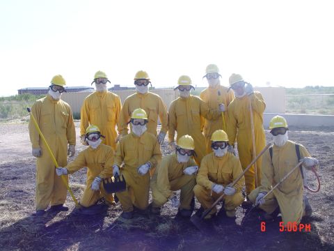 1981 Ford Bronco - A group of individuals in protective gear stand together in an outdoor setting, appearing to be part of a training exercise.