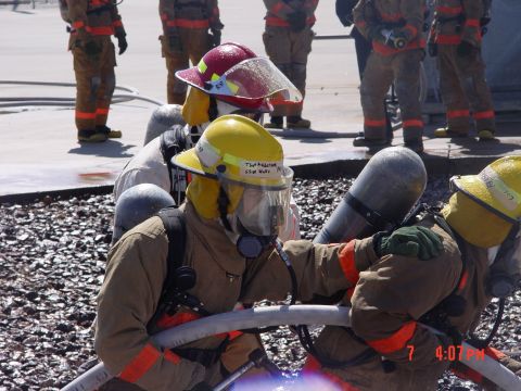 1981 Ford Bronco - Firefighters train with hoses, demonstrating their readiness for emergency situations.