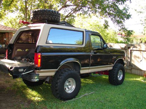 1996 Ford Bronco - This 1996 Ford Bronco features a two-tone paint scheme and an external spare tire mount on its roof rack.