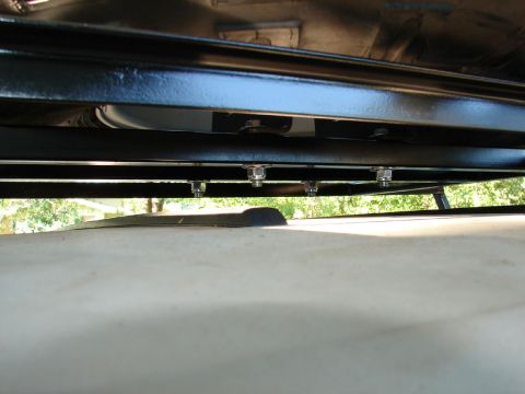 1996 Ford Bronco - Close-up of roof rack mounting hardware on a vehicle's underside.