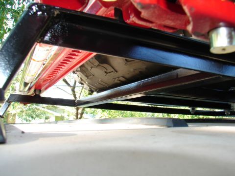1996 Ford Bronco - A hi-lift jack and spare tire are secured to a roof rack system.