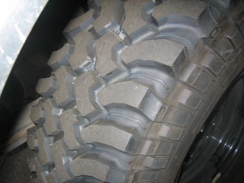 1995 Ford Bronco - This image shows a close-up view of an aggressive off-road tire tread pattern.