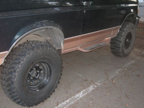 1995 Ford Bronco - Side view of a 1995 Ford Bronco, highlighting its body lines and lifted suspension.