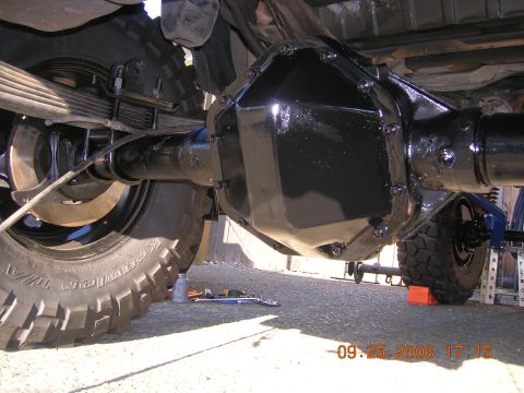 1996 Ford Bronco - Close-up view of the underside of a vehicle, focusing on the rear axle and suspension system.